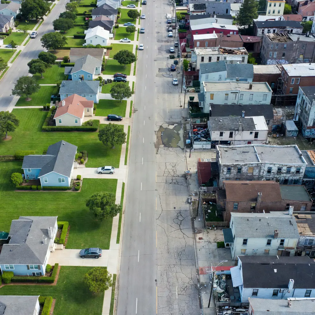 Urban housing inequality aerial view Aerial view contrasting wealthy and impoverished housing in the same American city, showing stark resource disparities